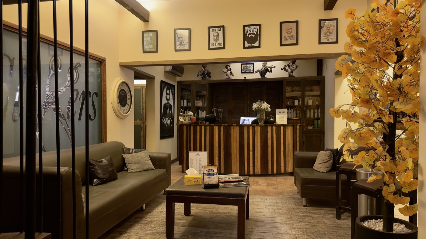 Leather sofas and a coffee table in the panelled lounge at the Stadium branch