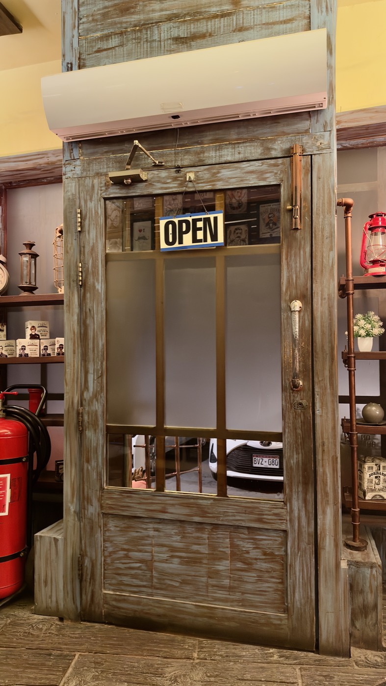 The timber and glass entrance door at the Zamzama branch