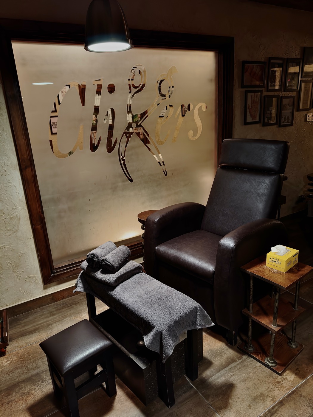 A leather pedicure chair beneath an etched Clippers glass panel at the Zamzama branch