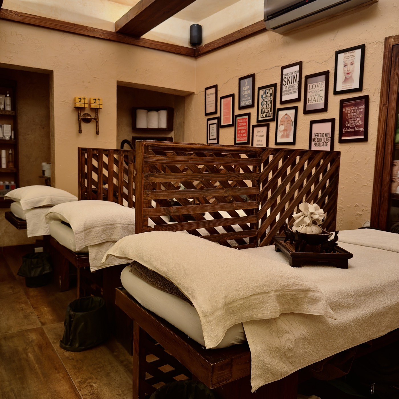 Treatment beds laid with fresh towels behind a lattice screen at the Zamzama branch
